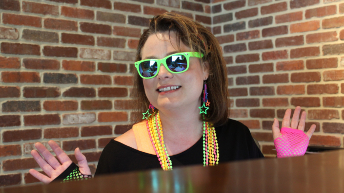ThemeWorks associate in colorful costumes and glasses.