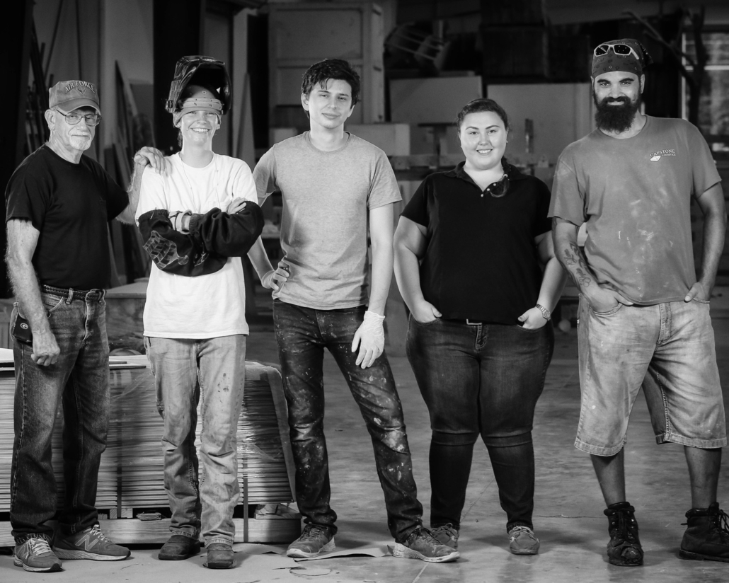 Five ThemeWorks associates in their work gear.
